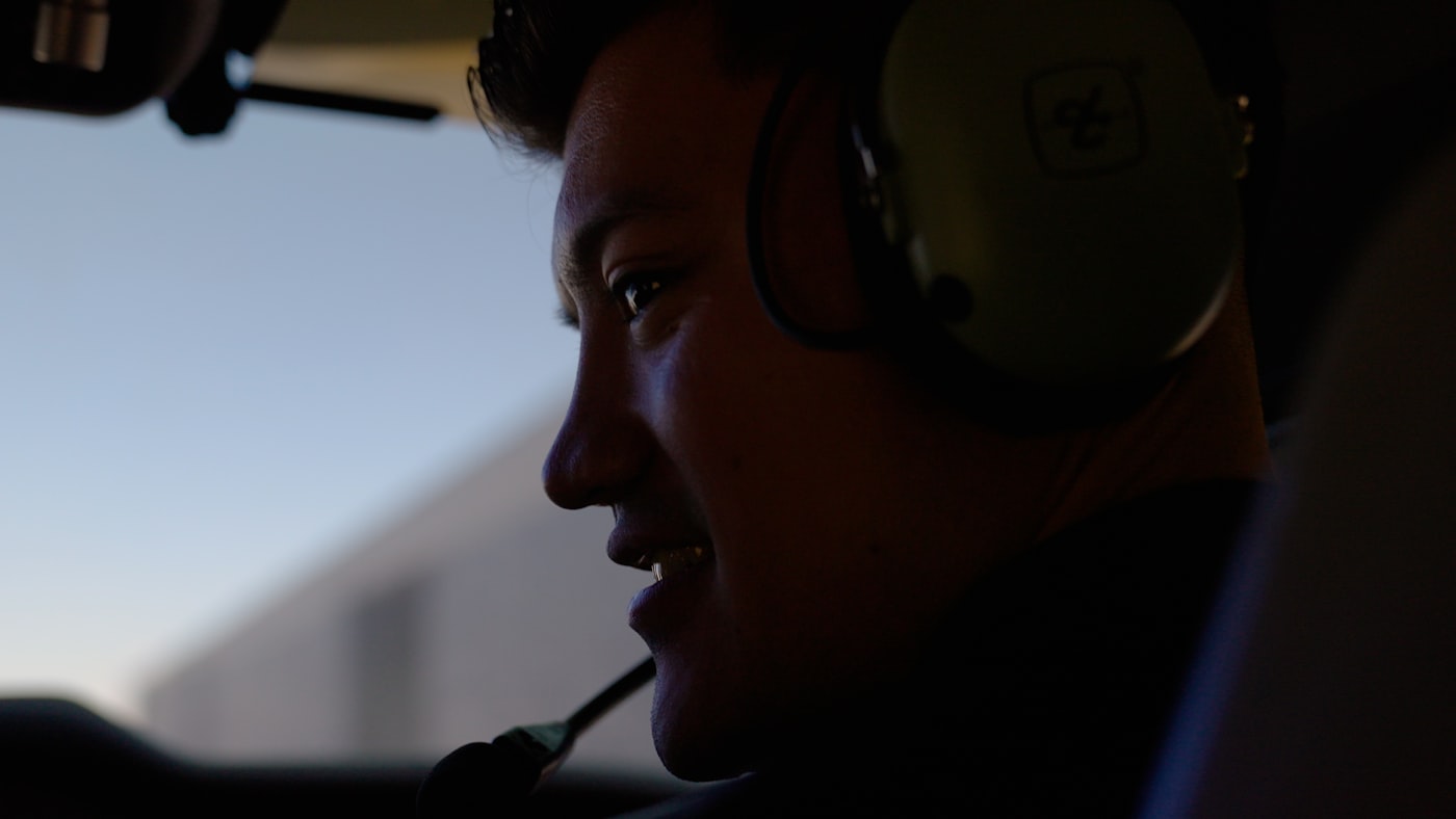 Airline pilot wearing a headset in the cockpit