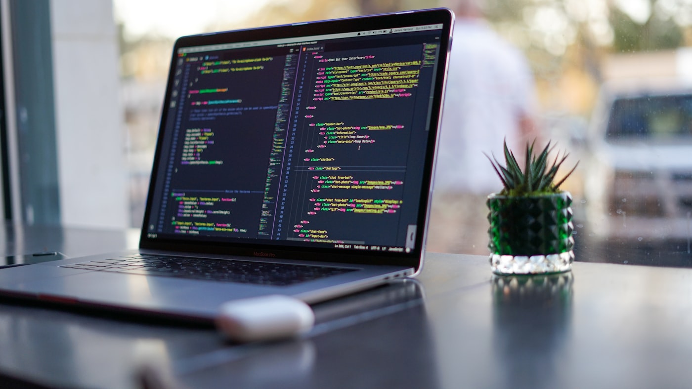 Developer's laptop with code on a desk